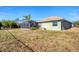 A well-maintained backyard featuring a screened-in pool and patio with lush greenery and landscaping at 9219 Newnan Cir, Port Charlotte, FL 33981