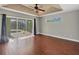 The main bedroom features hardwood floors, a ceiling fan and sliding glass doors to the pool at 9219 Newnan Cir, Port Charlotte, FL 33981