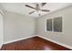 Bedroom features hardwood floors, a ceiling fan and a window at 9219 Newnan Cir, Port Charlotte, FL 33981