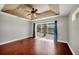 The main bedroom features hardwood floors, a ceiling fan and sliding glass doors to the pool at 9219 Newnan Cir, Port Charlotte, FL 33981