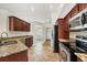 Cozy kitchen features cherry wood cabinets, granite countertops, and stainless steel appliances at 9219 Newnan Cir, Port Charlotte, FL 33981