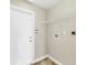 This laundry room features a white door, overhead shelf, and utility connections at 9219 Newnan Cir, Port Charlotte, FL 33981