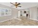 Bright living area featuring tile floors and views into the kitchen and backyard at 9219 Newnan Cir, Port Charlotte, FL 33981
