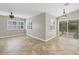 Bright living room with tile flooring and a sliding door to a screened patio at 9219 Newnan Cir, Port Charlotte, FL 33981