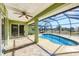 Relax by the screened-in pool with tiled flooring in this luxurious outdoor living space at 9219 Newnan Cir, Port Charlotte, FL 33981