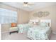 Charming bedroom featuring twin beds, a window, and coastal decor at 9330 Migue Cir, Port Charlotte, FL 33981