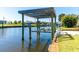 Boat lift situated on a tranquil canal offering convenient access to boating and water activities at 9330 Migue Cir, Port Charlotte, FL 33981