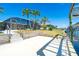 Backyard area featuring a private dock and enclosed lanai, perfect for outdoor living and enjoying waterfront views at 9330 Migue Cir, Port Charlotte, FL 33981