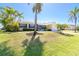 Charming home with lush landscaping, a well-manicured lawn, and a bright exterior, creating inviting curb appeal at 9330 Migue Cir, Port Charlotte, FL 33981