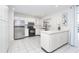 Bright kitchen with stainless steel appliances, white cabinets, tiled flooring and backyard views at 9330 Migue Cir, Port Charlotte, FL 33981