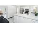 Bright kitchen with stainless steel appliances, white cabinets, and ample counter space at 9330 Migue Cir, Port Charlotte, FL 33981