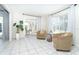 Bright living space with tile flooring, comfortable seating, and views to the lanai, perfect for relaxation at 9330 Migue Cir, Port Charlotte, FL 33981