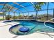Enjoy the views from this crystal-clear pool, complete with seating, that is surrounded by a screened enclosure at 9330 Migue Cir, Port Charlotte, FL 33981
