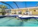 Delight in this screened pool, with a built-in sun shelf, offering a perfect blend of leisure and recreation at 9330 Migue Cir, Port Charlotte, FL 33981