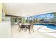 Dine outdoors in the screened lanai with views of the pool and the surrounding canal at 9330 Migue Cir, Port Charlotte, FL 33981