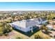 An aerial view showcases the modern home, lush landscaping, and serene neighborhood at 10447 New Brunswick St, Port Charlotte, FL 33981