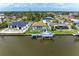An aerial view of a waterfront home with a screened-in pool and private boat dock at 10640 Ayear Rd, Port Charlotte, FL 33981