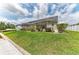 Green backyard featuring a screen enclosed lanai, perfect for entertaining, with water access at 10640 Ayear Rd, Port Charlotte, FL 33981