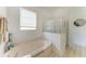 The bathroom features a soaking tub, tile floors, and a glass block window at 10640 Ayear Rd, Port Charlotte, FL 33981