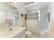 Well-lit bathroom with a shower/tub combo, light tile, and vanity with ample counter space at 10640 Ayear Rd, Port Charlotte, FL 33981