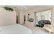 Light-filled bedroom offers a ceiling fan, dresser, and screened-in patio views at 10640 Ayear Rd, Port Charlotte, FL 33981