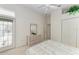 Comfortable bedroom featuring a dresser, closet and access to the patio at 10640 Ayear Rd, Port Charlotte, FL 33981