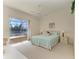 This bedroom has a large window with serene lake views and ceiling fan at 10640 Ayear Rd, Port Charlotte, FL 33981