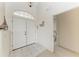 The entryway has double doors, tile flooring, and an arched transom window for natural light at 10640 Ayear Rd, Port Charlotte, FL 33981