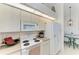 Efficient kitchen with white appliances, ample counter space, and adjacent dining area at 10640 Ayear Rd, Port Charlotte, FL 33981