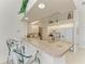Kitchen with breakfast bar, white appliances, and ample counter space for meal preparation at 10640 Ayear Rd, Port Charlotte, FL 33981