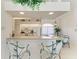 Charming kitchen with a breakfast bar, white cabinets, and stylish lighting fixtures at 10640 Ayear Rd, Port Charlotte, FL 33981
