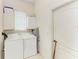 Convenient laundry room with a washer, dryer, storage cabinets, and access to the exterior at 10640 Ayear Rd, Port Charlotte, FL 33981