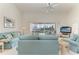 Bright living room with comfortable seating and sliding glass doors to pool area at 10640 Ayear Rd, Port Charlotte, FL 33981