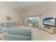 Cozy living room with plush furniture, television, and access to the screened lanai and pool at 10640 Ayear Rd, Port Charlotte, FL 33981