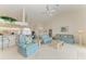 Open-concept living room featuring comfortable furniture, high ceilings, and access to the kitchen at 10640 Ayear Rd, Port Charlotte, FL 33981