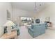 A bright living room features high ceilings, neutral carpet, and access to a screened-in patio at 10640 Ayear Rd, Port Charlotte, FL 33981