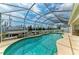 Screened-in pool with waterway views offers the perfect outdoor entertaining space and relaxation at 10640 Ayear Rd, Port Charlotte, FL 33981