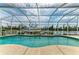 Backyard pool area features a waterfront view, boat dock and screened-in enclosure at 10640 Ayear Rd, Port Charlotte, FL 33981