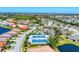 An aerial view of the community showcasing tennis courts and a pool surrounded by lush greenery at 1104 Yosemite Dr, Englewood, FL 34223
