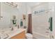 Bathroom featuring a well lit vanity with an updated mirror, along with a combined shower and bathtub at 1104 Yosemite Dr, Englewood, FL 34223