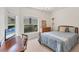 Cozy bedroom features a well lit area with an outdoor view and a convenient desk space for work or study at 1104 Yosemite Dr, Englewood, FL 34223