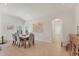 Bright dining room featuring neutral walls, tile flooring, a wooden table, and six comfortable chairs at 1104 Yosemite Dr, Englewood, FL 34223