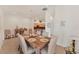 Dining room with tan tile flooring and seating for six. Kitchen area is visible in the background at 1104 Yosemite Dr, Englewood, FL 34223