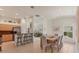 Bright dining area featuring a bar with stools and a dining table with seating for six, open to the living space at 1104 Yosemite Dr, Englewood, FL 34223