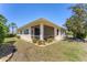 Well-maintained home exterior with a screened in patio and landscaping, offering a serene outdoor living space at 1104 Yosemite Dr, Englewood, FL 34223