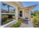 Inviting front entrance with a well-maintained walkway, lush landscaping, and natural light from the large window at 1104 Yosemite Dr, Englewood, FL 34223