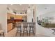Open-concept kitchen with breakfast bar seating, stainless steel appliances, and a view into the living area at 1104 Yosemite Dr, Englewood, FL 34223