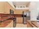 Bright kitchen featuring stainless steel appliances, granite countertops, and ample cabinet space with decorative backsplash at 1104 Yosemite Dr, Englewood, FL 34223