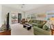 Inviting living room with a plush sofa, sliding glass doors, and a serene outdoor view at 1104 Yosemite Dr, Englewood, FL 34223