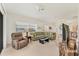 Spacious living room with comfortable seating, large windows, and seamless flow to the dining area at 1104 Yosemite Dr, Englewood, FL 34223